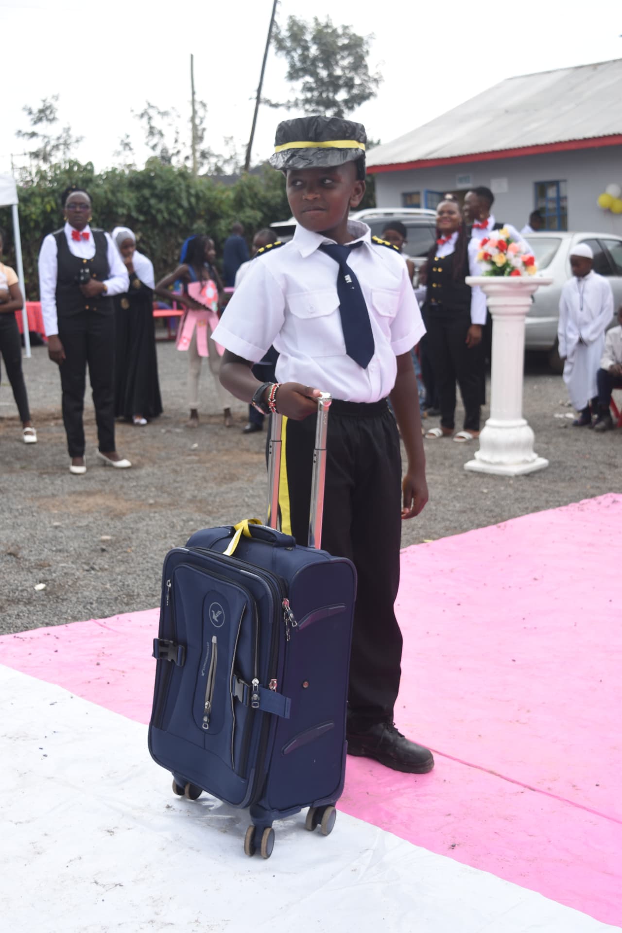 Myfin School learner dressed as a pilot with a suitcase during a career day parade