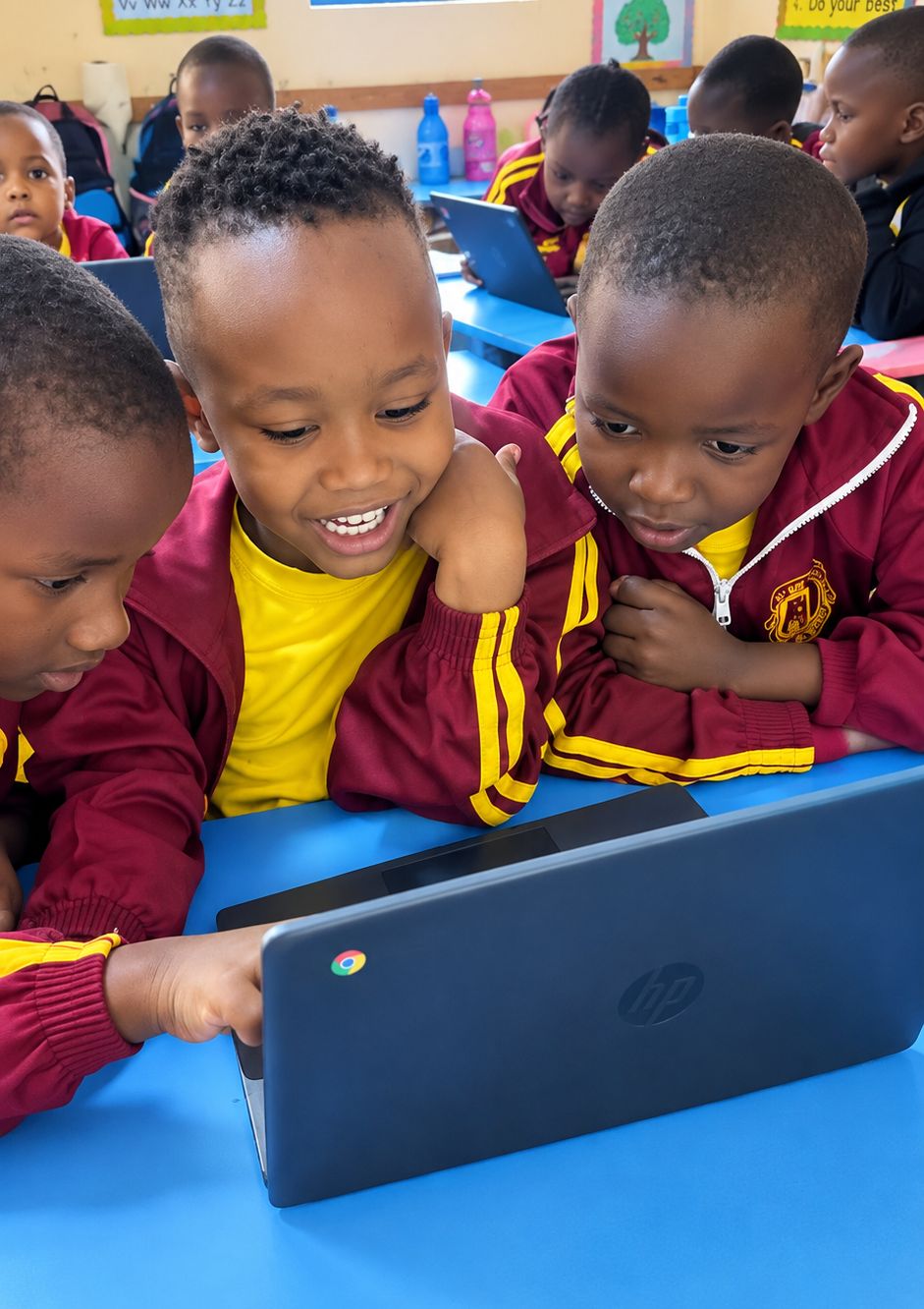 Smiling Myfin School learners gathered around a laptop in an AI and robotics class