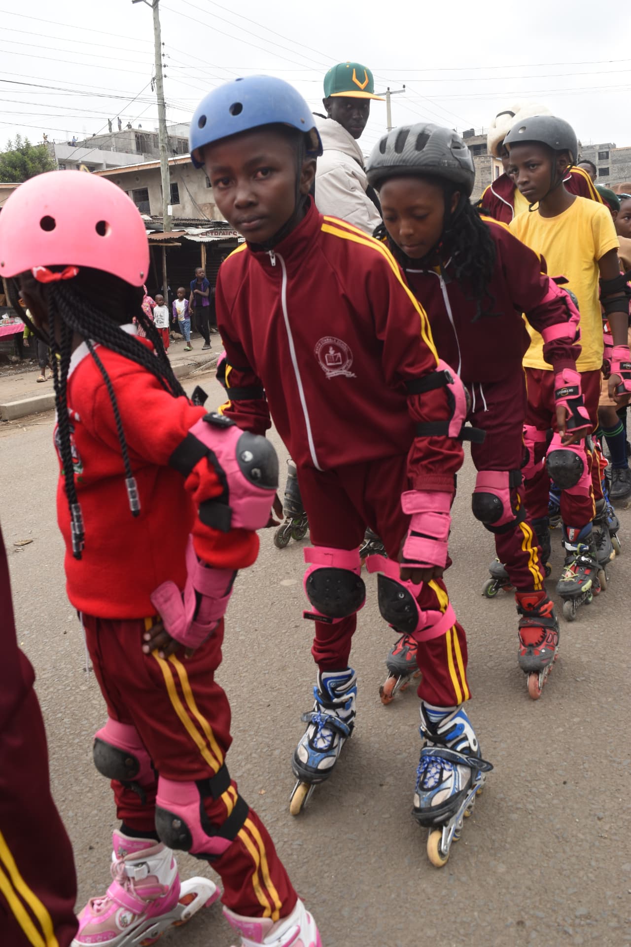 Myfin School skating team in maroon tracksuits and safety gear